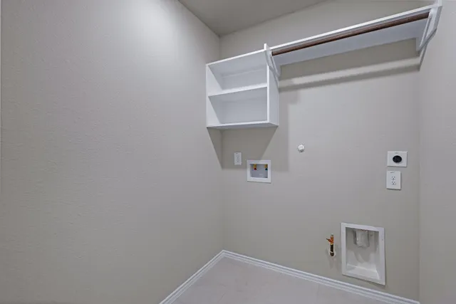 a view of storage and utility room with racks on the wall