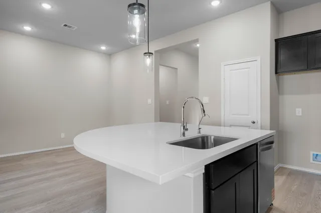 a kitchen with a sink and chandelier