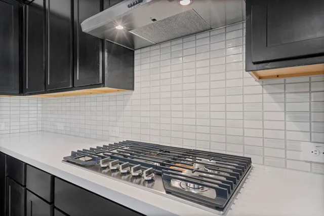 a stove top oven sitting inside of a kitchen