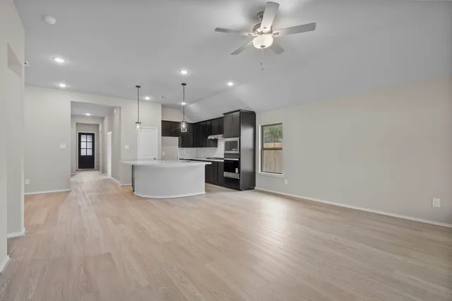 a view of a kitchen with a sink and a refrigerator