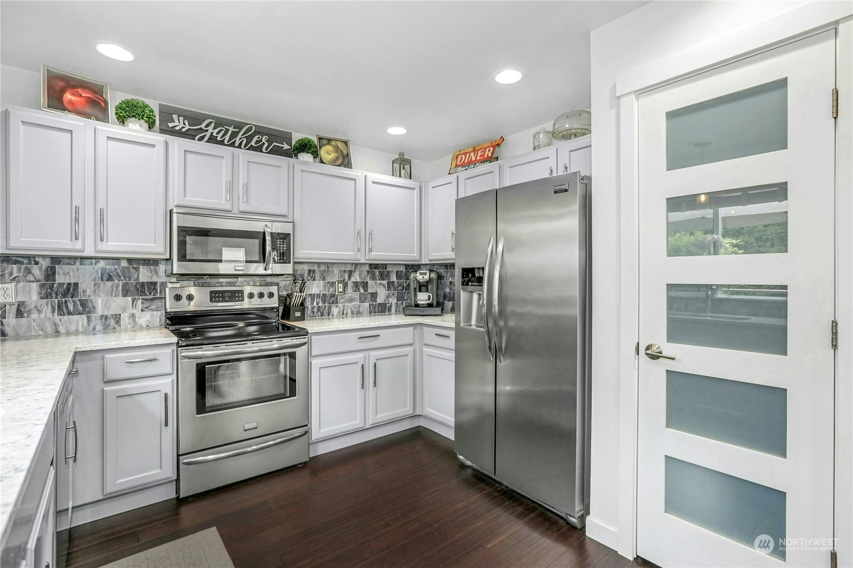 15028 51st Drive Southeast Bothell, WA 98012 - Photo 13 of 31 a kitchen with granite countertop stainless steel appliances and wooden cabinets