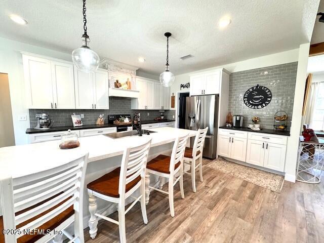 34424 Mitigation Trail Callahan, FL 32011 - Photo 11 of 44 a kitchen with stainless steel appliances kitchen island granite countertop a stove a sink and a refrigerator