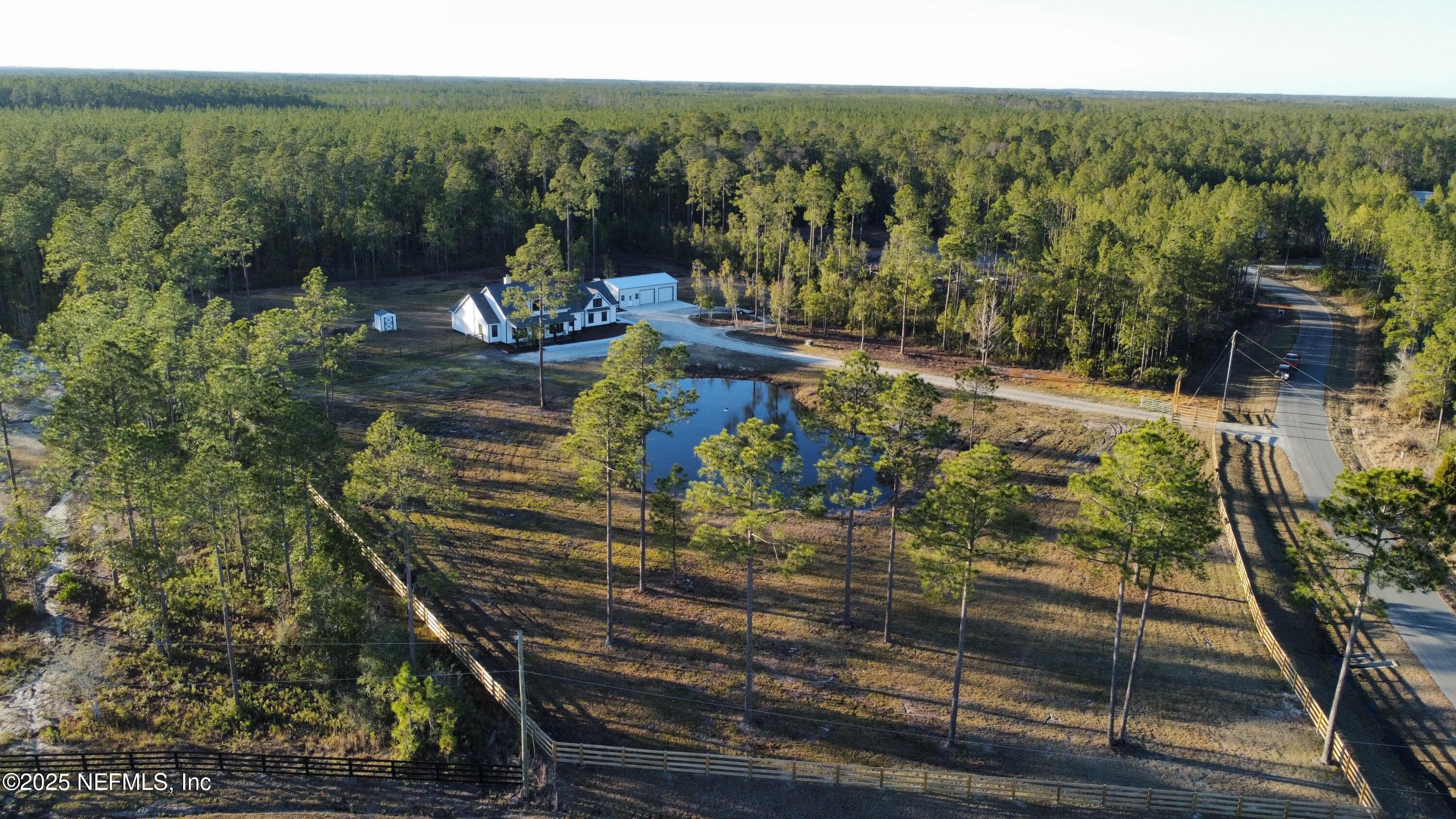 34424 Mitigation Trail Callahan, FL 32011 - Photo 37 of 44 a view of a yard with table and chairs