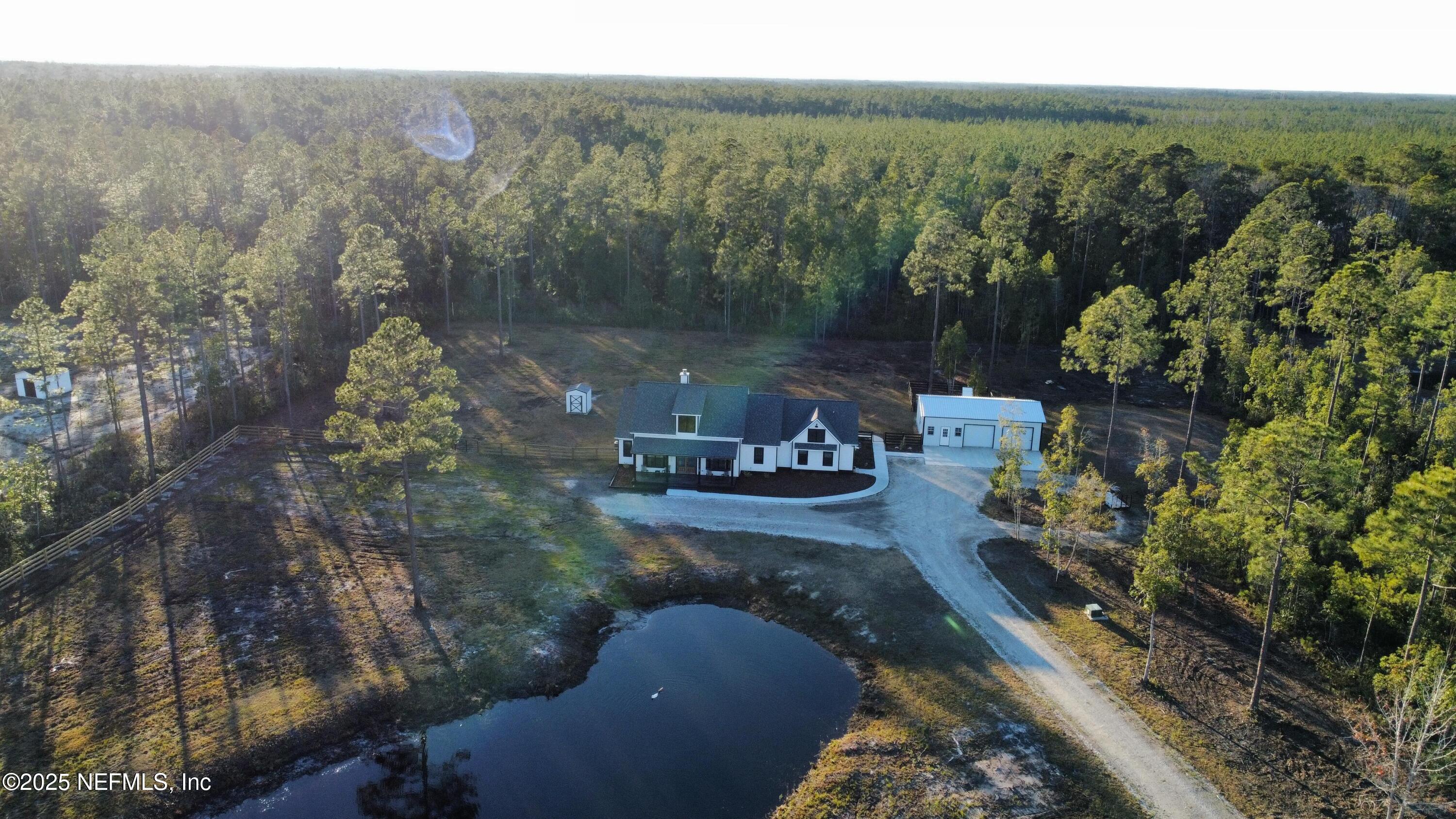34424 Mitigation Trail Callahan, FL 32011 - Photo 38 of 44 a view of a lake with outdoor space