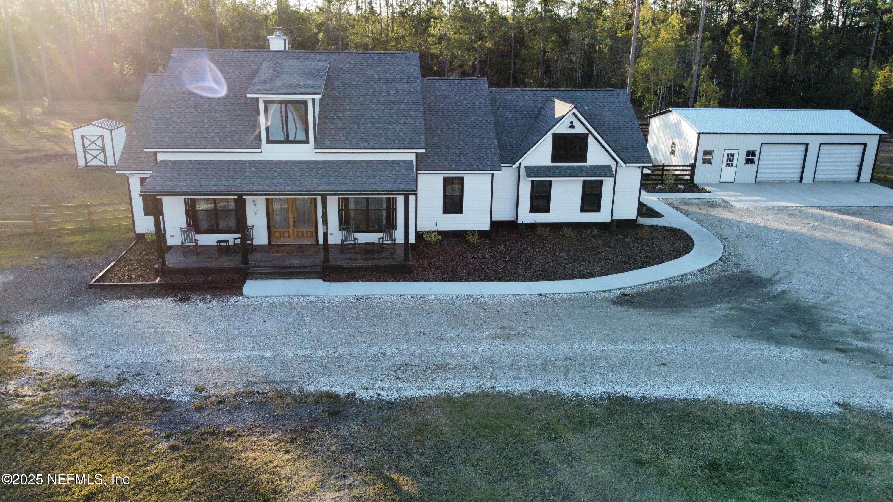 34424 Mitigation Trail Callahan, FL 32011 - Photo 40 of 44 a front view of a house with a garden