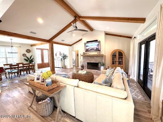 34424 Mitigation Trail Callahan, FL 32011 - Photo 8 of 44 a living room with furniture a fireplace and a floor to ceiling window