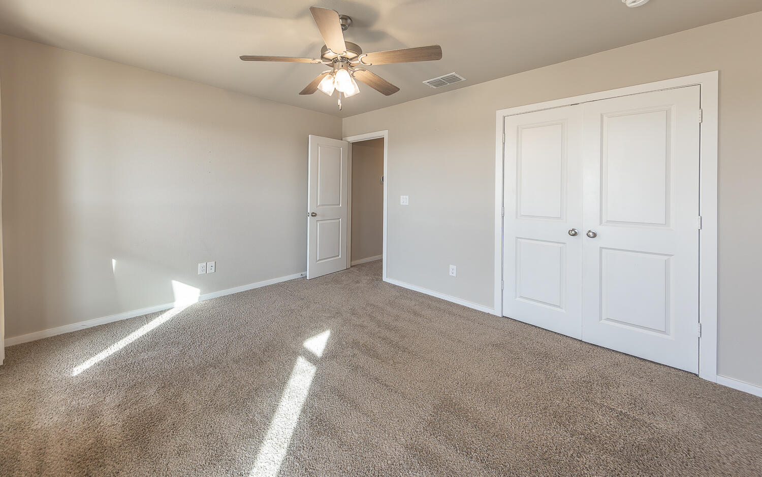 7526 31st Place Lubbock, TX 79407 - Photo 14 of 22 a view of an empty room with a ceiling fan