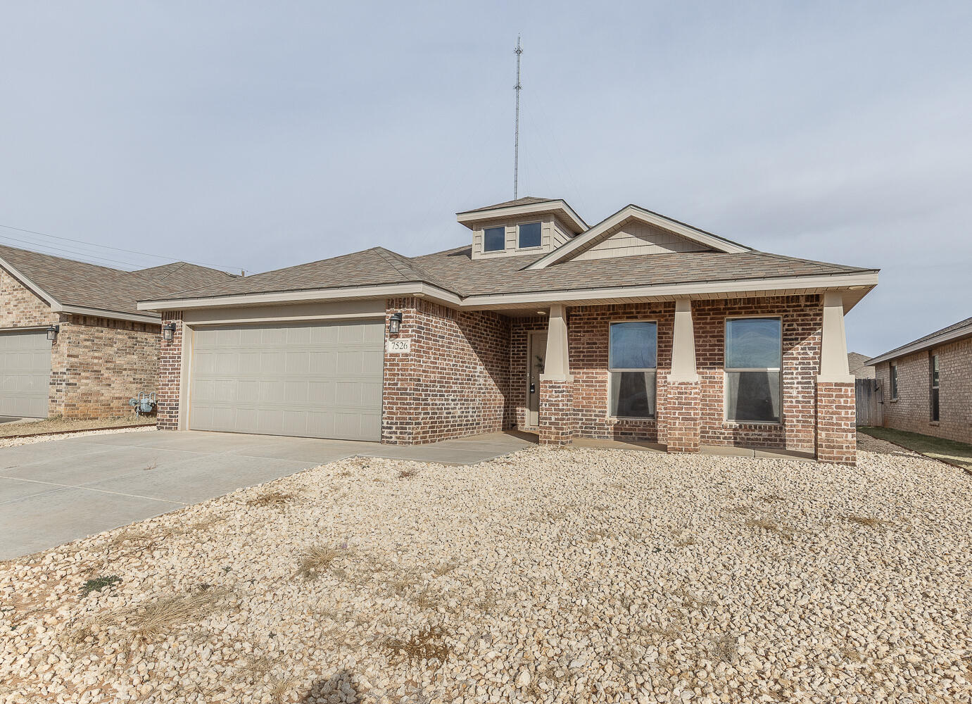 7526 31st Place Lubbock, TX 79407 - Photo 21 of 22 a front view of a house with a yard and garage