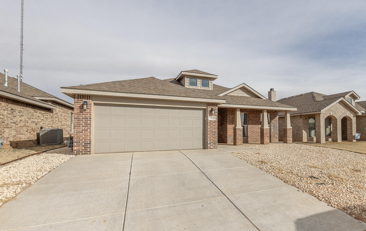 7526 31st Place Lubbock, TX 79407 - Photo 22 of 22 a front view of a house with a yard and garage