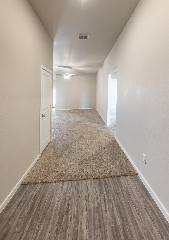 7526 31st Place Lubbock, TX 79407 - Photo 4 of 22 a view of a room with wooden floor