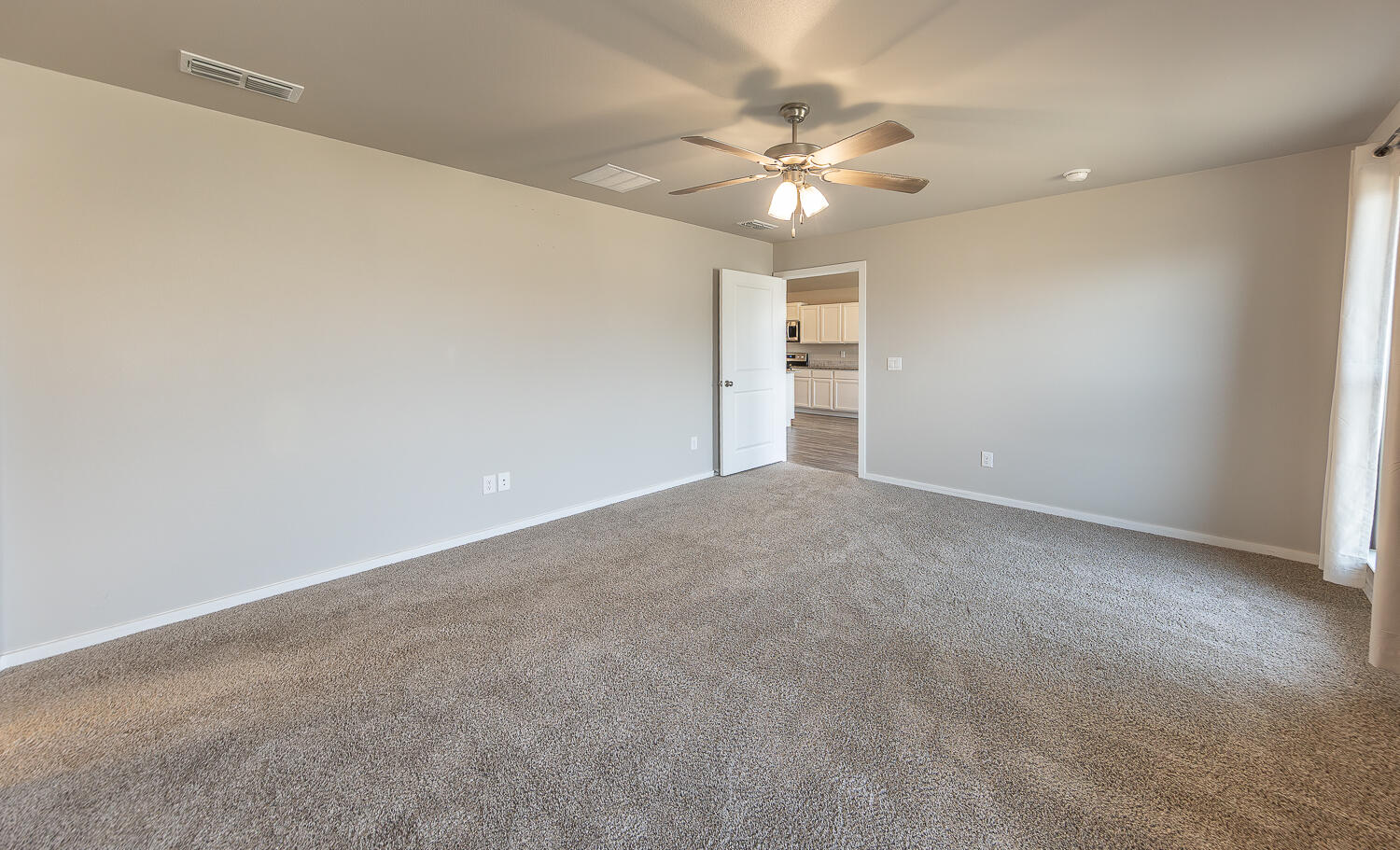 7526 31st Place Lubbock, TX 79407 - Photo 10 of 22 a view of an empty room with a chandelier fan