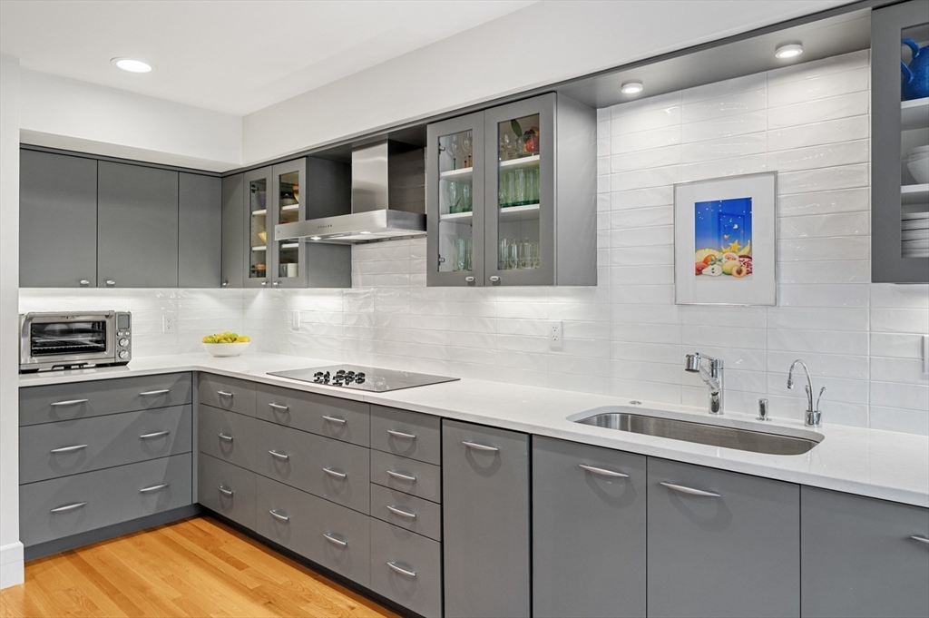 277 Nahanton Street, Unit 277 Newton, MA 02459 - Photo 17 of 39 a kitchen with a sink and cabinets