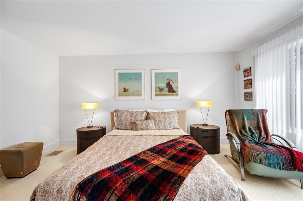 277 Nahanton Street, Unit 277 Newton, MA 02459 - Photo 18 of 39 a bedroom with a bed a couch and a window