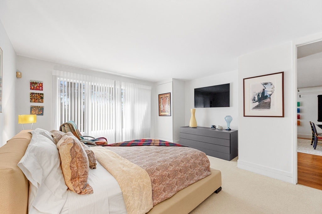 277 Nahanton Street, Unit 277 Newton, MA 02459 - Photo 20 of 39 a bedroom with a bed and a flat screen tv