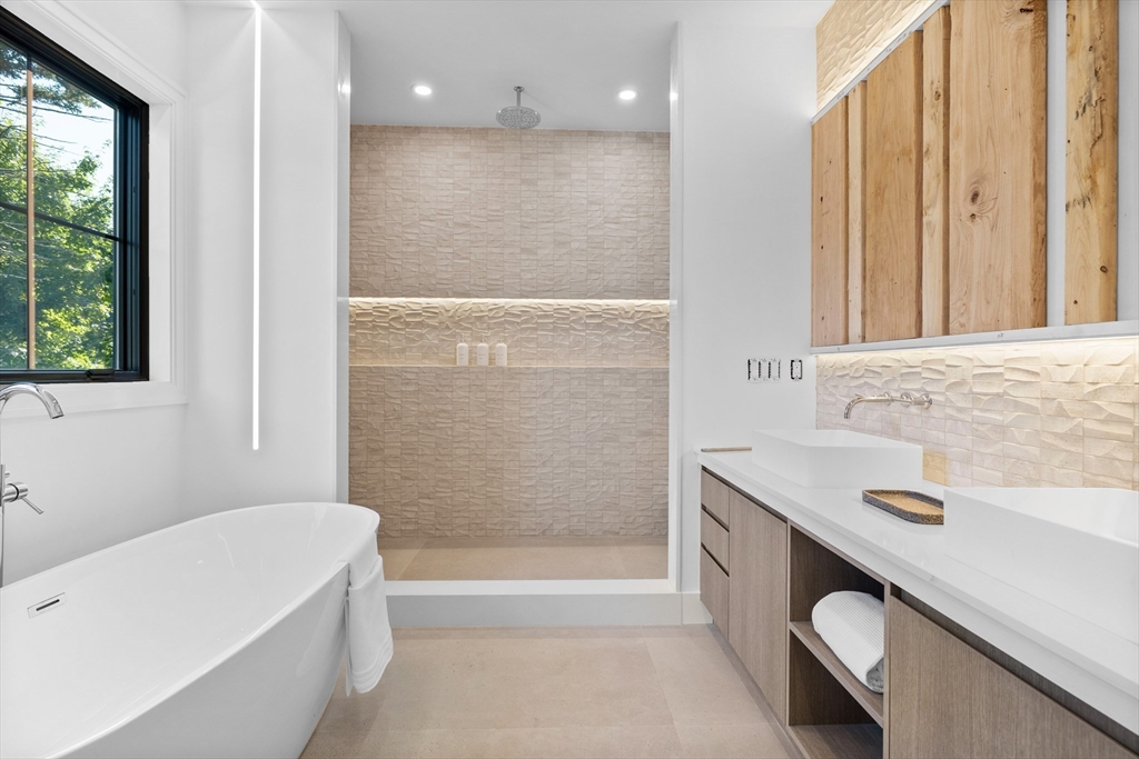 34 Garrison Road Wellesley, MA 02482 - Photo 14 of 28 a bathroom with a tub sink and mirror
