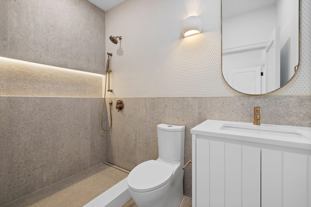 34 Garrison Road Wellesley, MA 02482 - Photo 18 of 28 a bathroom with a toilet a sink and mirror