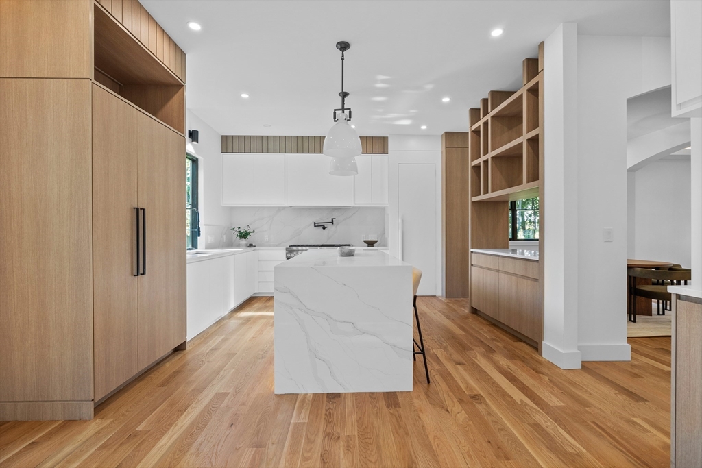 34 Garrison Road Wellesley, MA 02482 - Photo 5 of 28 a large white kitchen with wooden floor and a large window