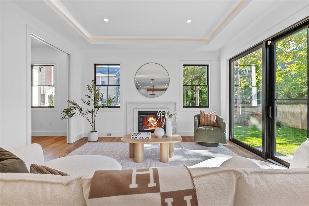 34 Garrison Road Wellesley, MA 02482 - Photo 8 of 28 a living room with furniture a fireplace and a large window
