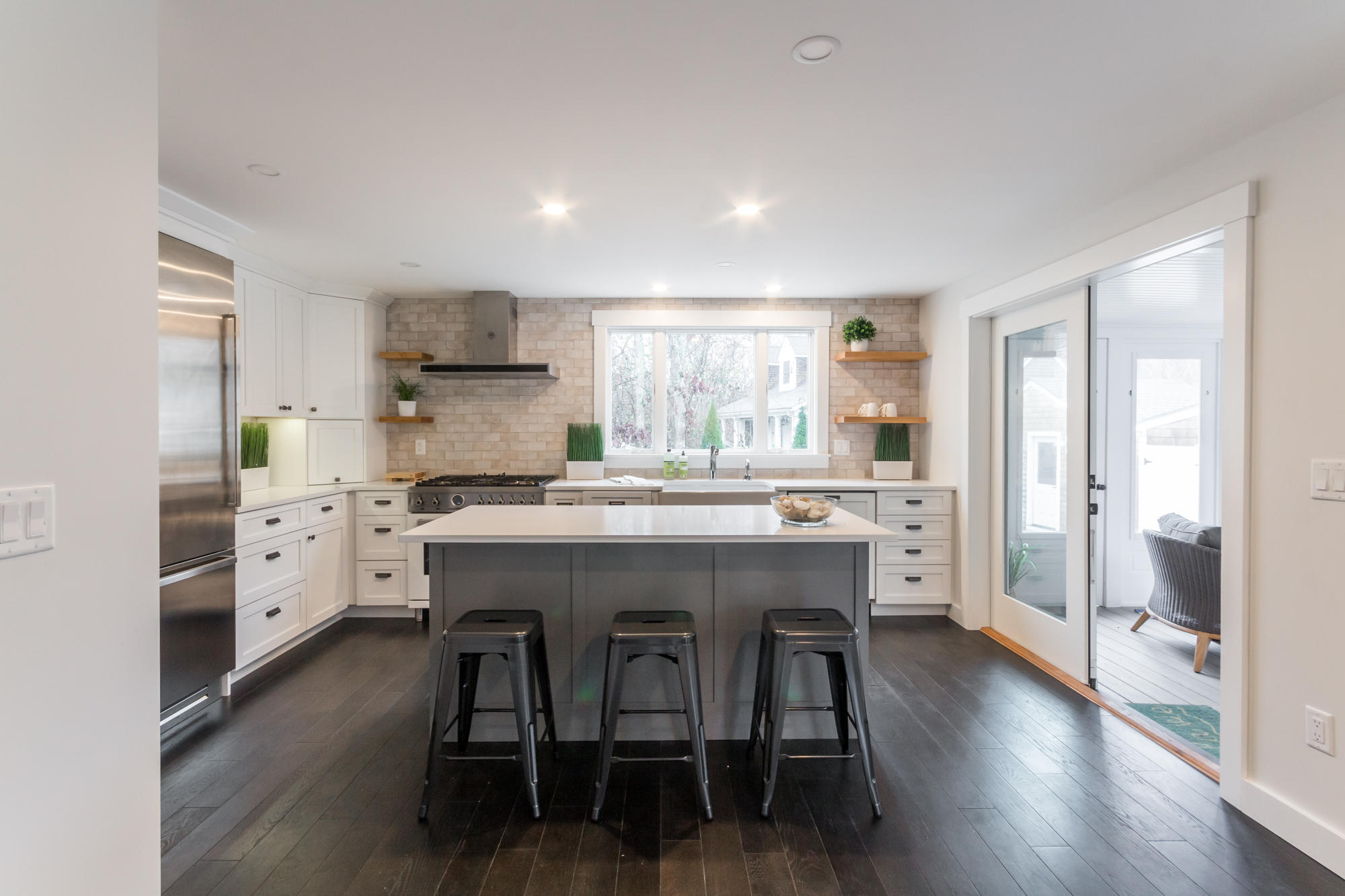 2 Marthas Road Edgartown, MA 02539 - Photo 5 of 25 a kitchen with stainless steel appliances a dining table chairs refrigerator and cabinets