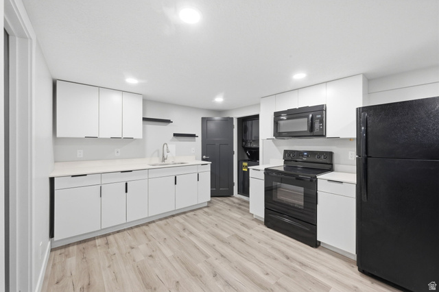 1795 South 200 West Bountiful, UT 84010 - Photo 17 of 37 Kitchen featuring black appliances, light countertops, white cabinetry, light wood-style flooring, and recessed lighting