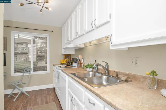 a kitchen with stainless steel appliances a sink a stove and a window