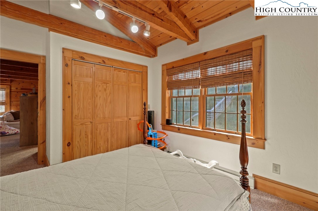 431 Silas Creek Road Lansing, NC 28643 - Photo 30 of 46 a bedroom with a bed and wooden floor