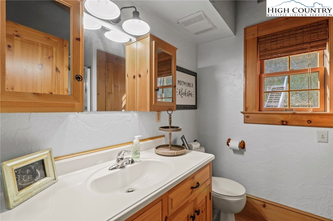 431 Silas Creek Road Lansing, NC 28643 - Photo 31 of 46 a bathroom with a sink and a mirror