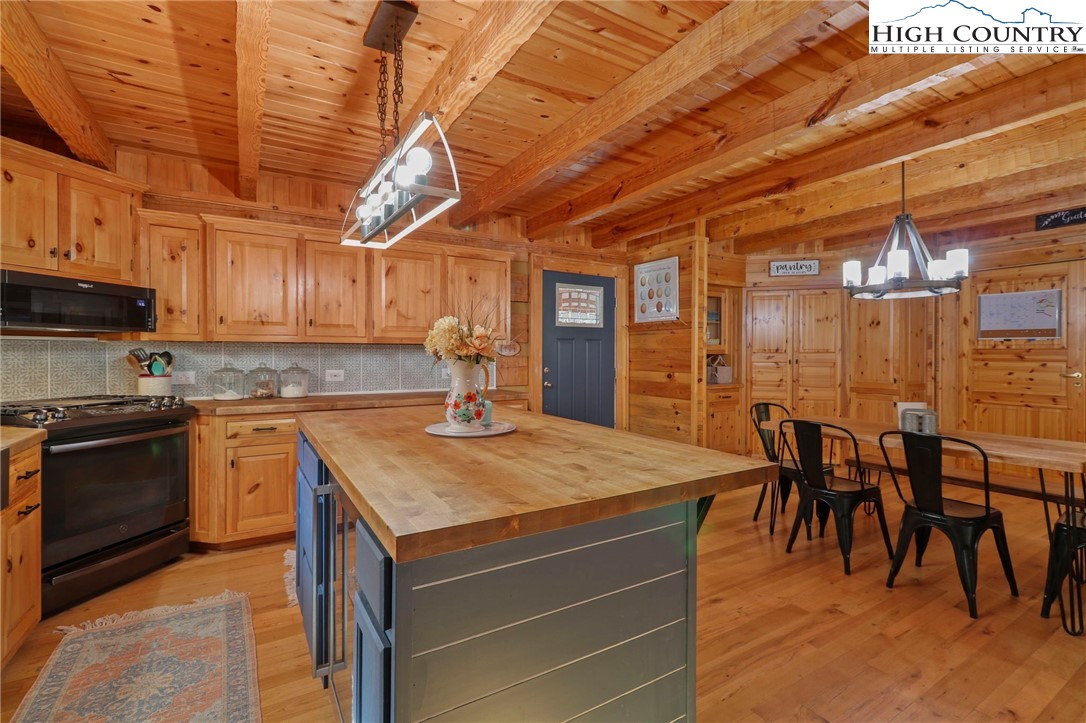 431 Silas Creek Road Lansing, NC 28643 - Photo 8 of 46 a kitchen with a stove a sink and a refrigerator