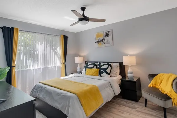 a bedroom with bed and window