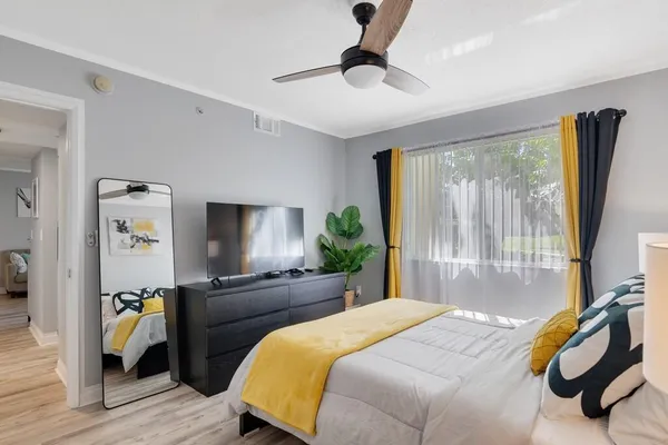 a bedroom with a bed and glass door