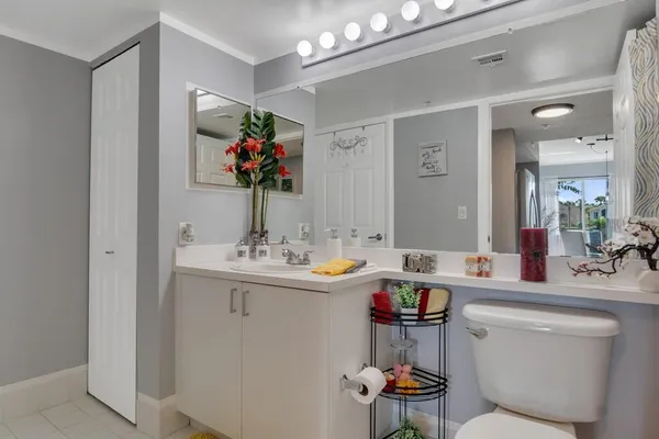 a bathroom with a sink mirror and toilet