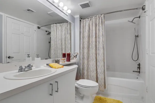 a bathroom with a sink toilet and shower