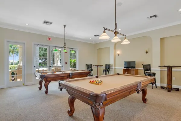 a room with a table chairs and a table