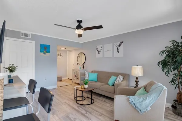 a living room with furniture and wooden floor