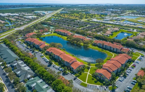 an aerial view of a resort with swimming pool outdoor seating