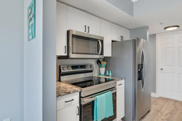 a kitchen with a refrigerator stove and microwave