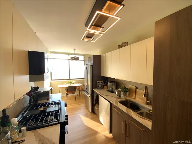a kitchen with a large window appliances and cabinets