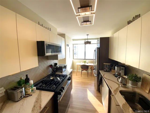 a kitchen with stainless steel appliances a sink a stove and a refrigerator