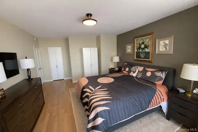 a bedroom with bed and a night stand