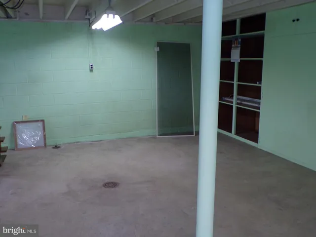 a view of an empty room with a fan