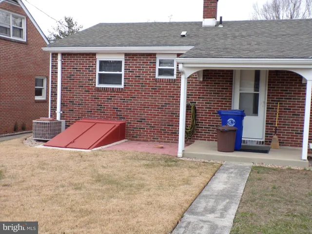 a view of a house with brick walls