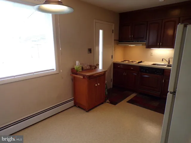 a kitchen with a refrigerator and a sink