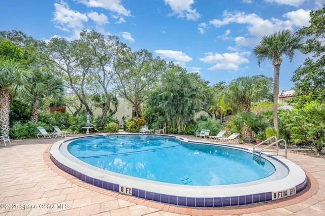 a view of a swimming pool with a yard