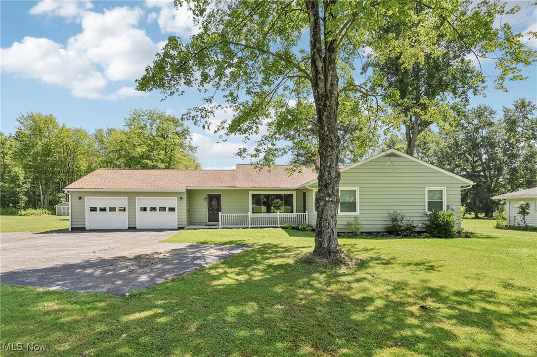 5097 Chillicothe Road Chagrin Falls, OH 44022 - Photo 1 of 45 Ranch-style house with asphalt driveway, a garage, a front lawn, and a porch