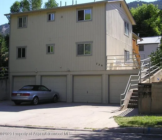 a view of a car parked front of a house