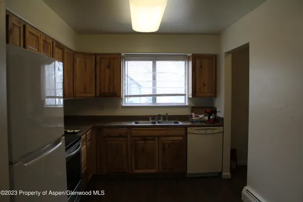a kitchen with stainless steel appliances a sink stove and cabinets
