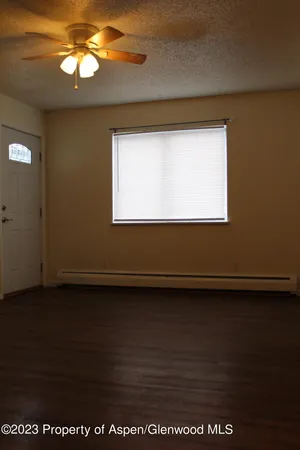 a view of wooden floor and windows in an empty room