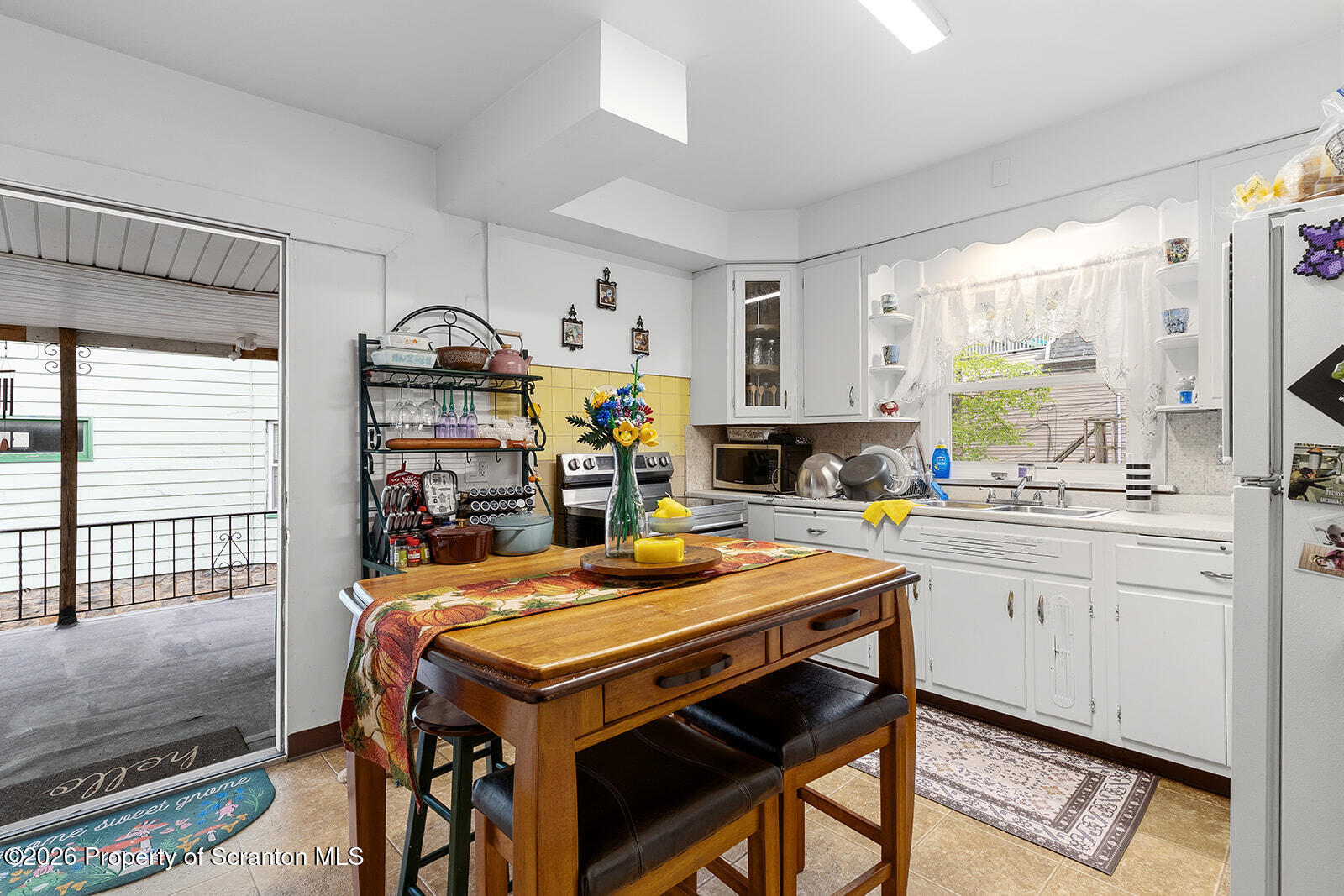 846 Monroe Avenue Scranton, PA 18510 - Photo 41 of 87 a room with stainless steel appliances kitchen island granite countertop a table chairs in it and wooden floors