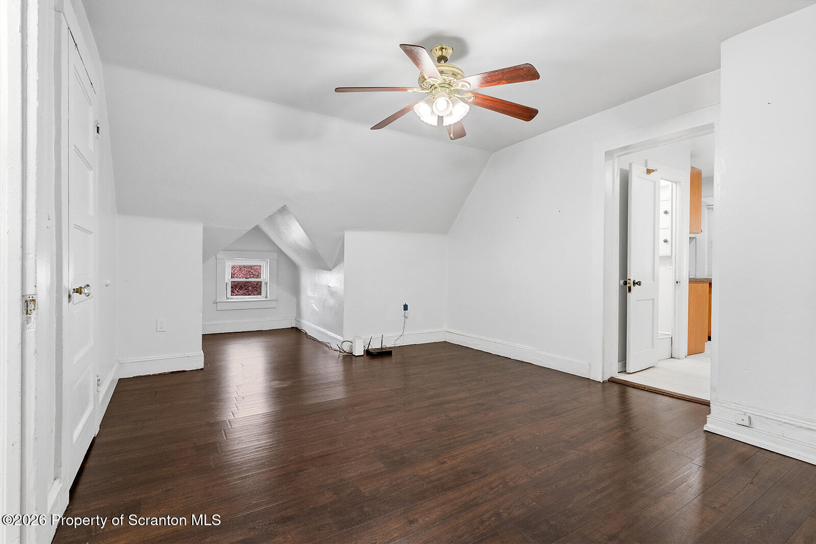 846 Monroe Avenue Scranton, PA 18510 - Photo 45 of 87 an empty room with wooden floor chandelier fan and windows