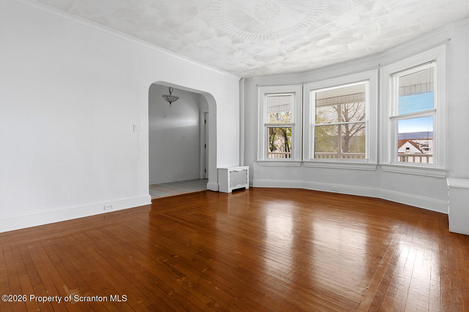 846 Monroe Avenue Scranton, PA 18510 - Photo 10 of 87 an empty room with wooden floor and windows
